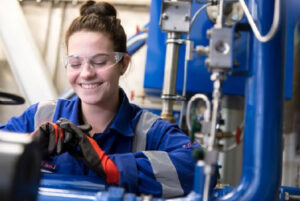 A woman working with industrial equipment.
