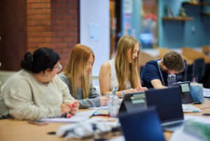 A group of students at a desk.